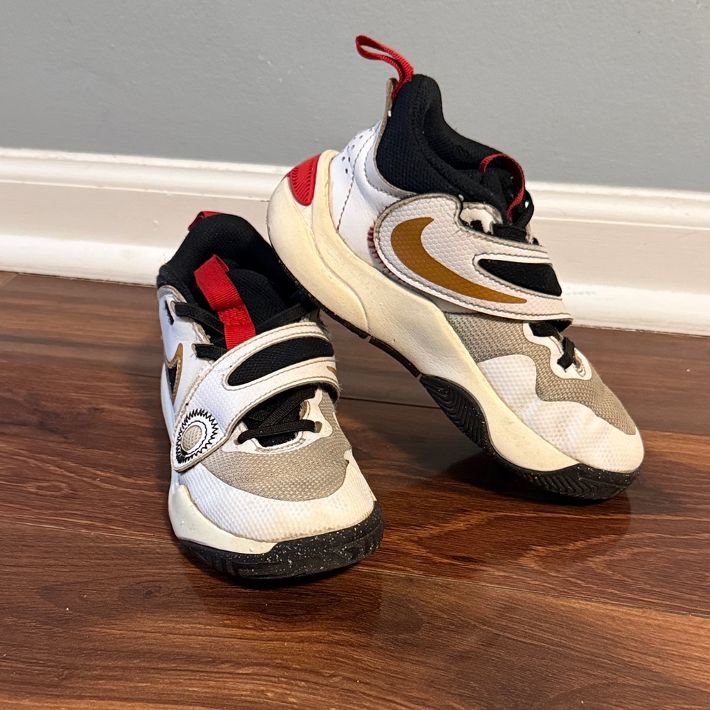 Nike Kids Athletic Shoes with Gold and Black Accents